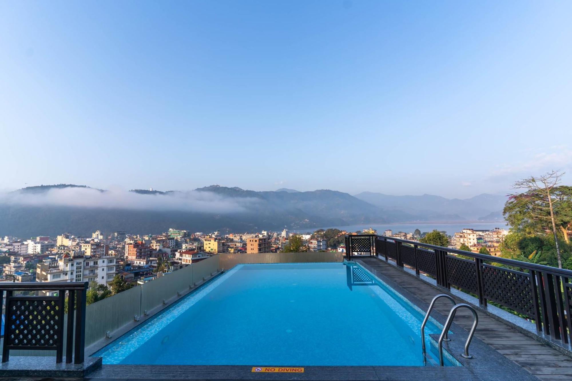 Bar Peepal Resort Pokhara Bagian luar foto View of the city from the hotel